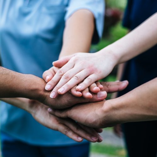cerca-de-los-estudiantes-del-equipo-de-trabajo-en-equipo-pila-de-manos-juntas-inicio-concepto-de-exito